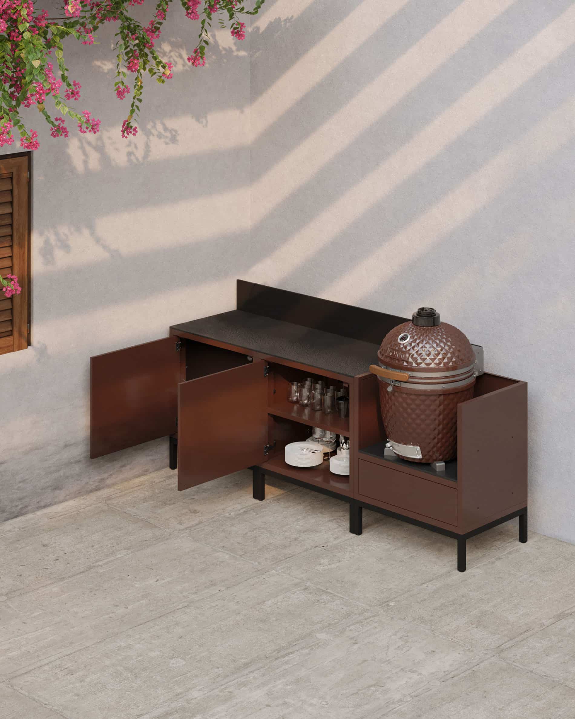 Cocina exterior sobre pilotis con acabado óxido, puertas abiertas, encimera oscura, espacios de almacenamiento interiores visibles y módulo kamado integrado para una cocina funcional al aire libre.